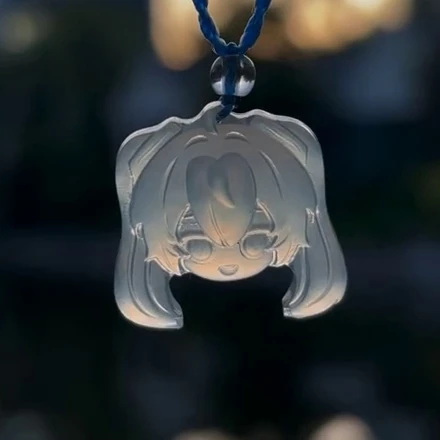 Hatsune Miku pendant D37B with a smiling face and twin tails, shown on a blue cord