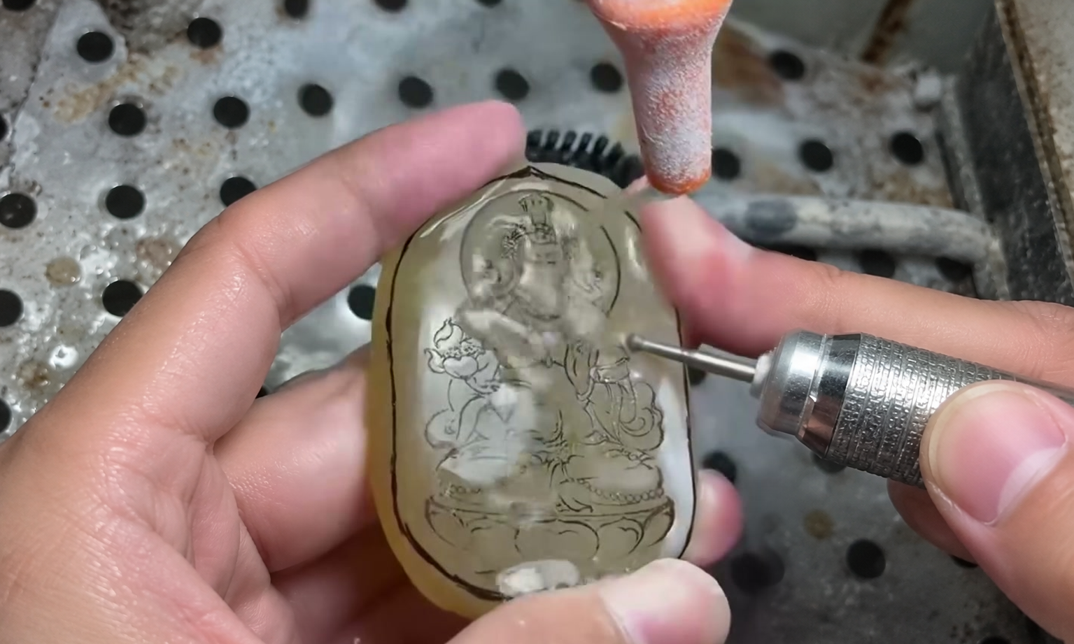 Original video still of a marked stone plaque and working carving tip, with AI-assisted background extension for the cover.